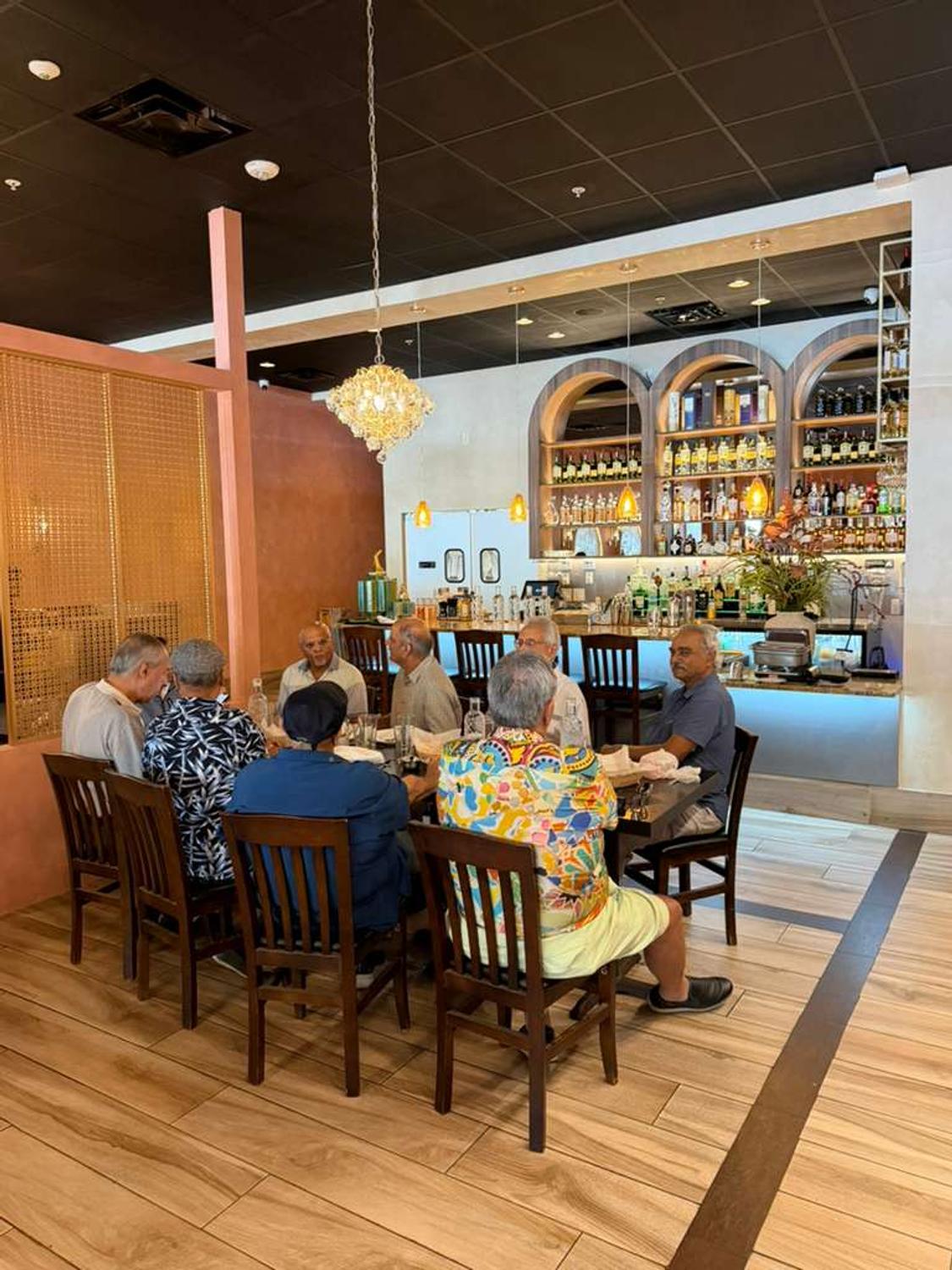 Dining tables set along the arched wall at Bombay Grove
