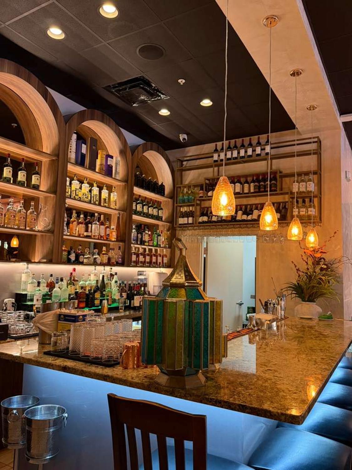 Guests dining beside the bar at Bombay Grove