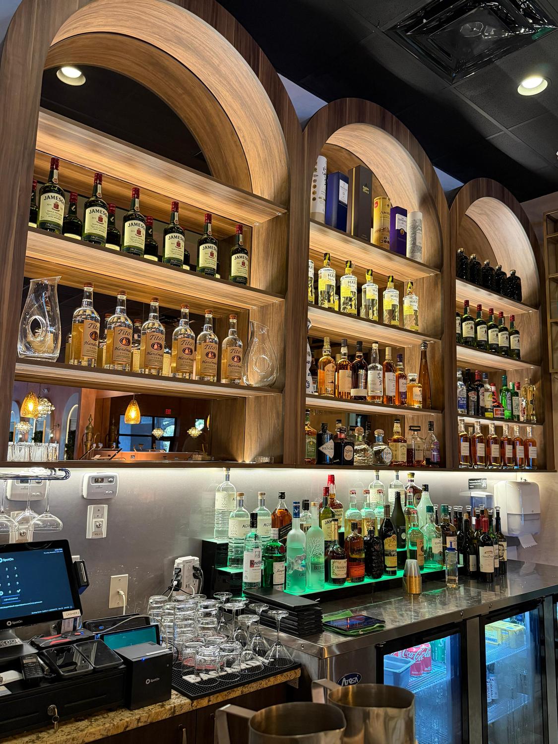 Arched back-bar shelves stocked with spirits